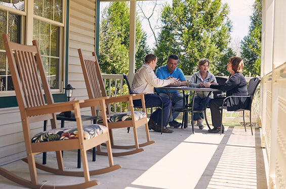 A family discuses a legacy plan on the porch.