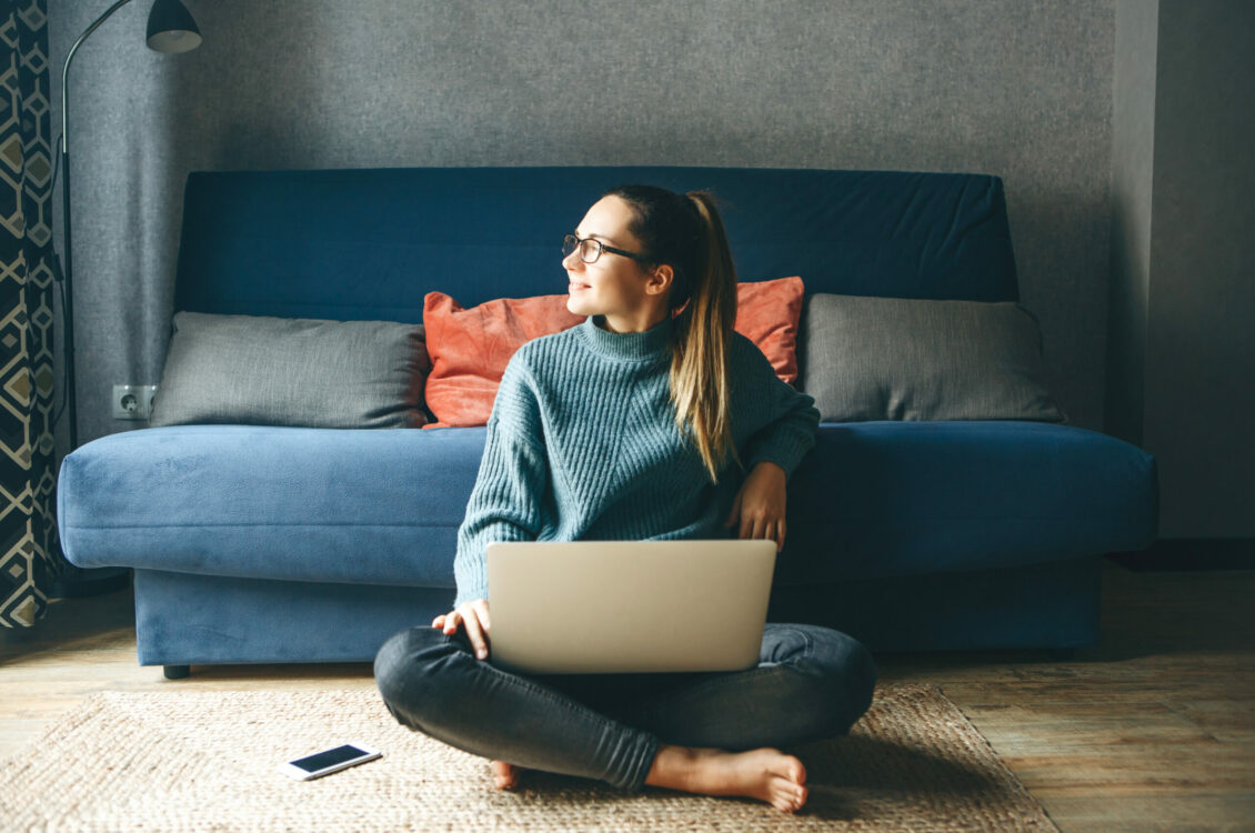 Girl working on laptop from home or student studying from home or freelancer. Or she is watching a video or using the Internet