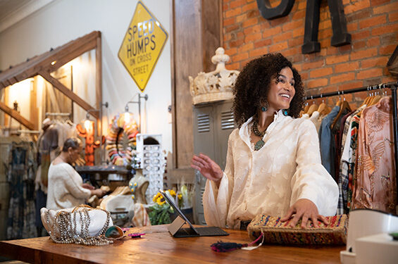 A shop owner behind the sales counter desk.