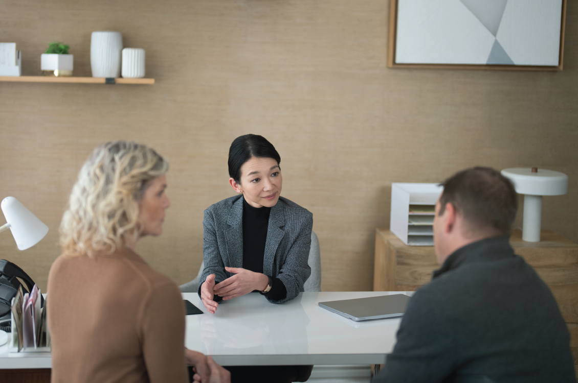 A professional having a meeting with two clients.