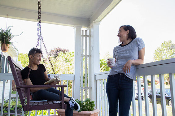 Two people chatting in the porch.