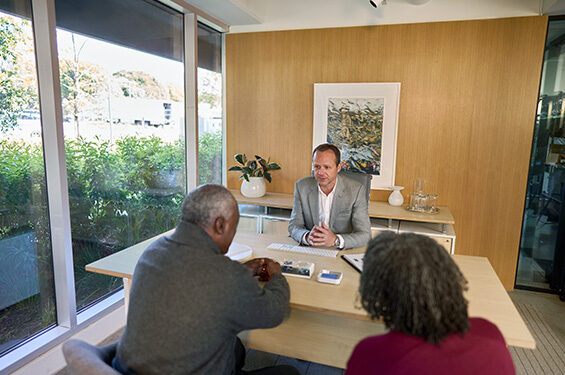 A professional having a meeting with a couple of clients.