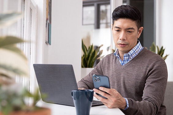 A man reading a news update on his phone.